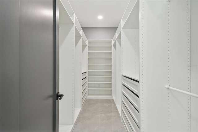 walk in closet with light tile patterned flooring