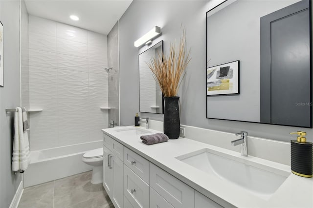 full bathroom featuring tile patterned floors, vanity, tiled shower / bath, and toilet