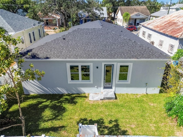 back of house with a lawn