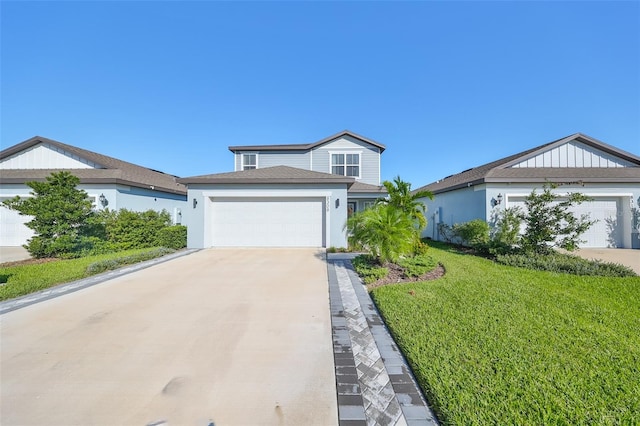 view of front of home with a front yard and a garage