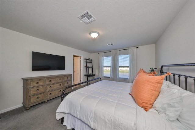 carpeted bedroom featuring a textured ceiling