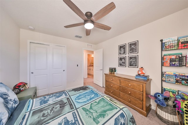 carpeted bedroom featuring a closet and ceiling fan