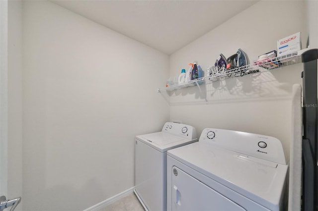 washroom featuring independent washer and dryer and light tile patterned floors