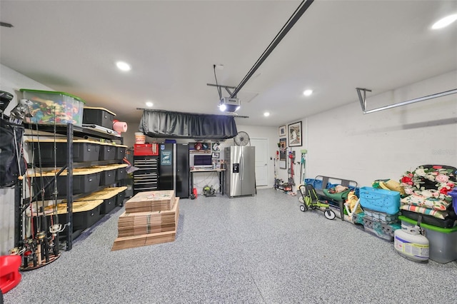 garage featuring a garage door opener and stainless steel fridge with ice dispenser