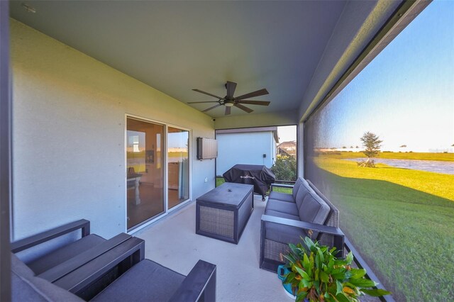 sunroom featuring ceiling fan