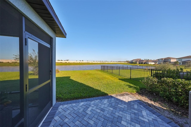 view of yard with a patio area and a water view