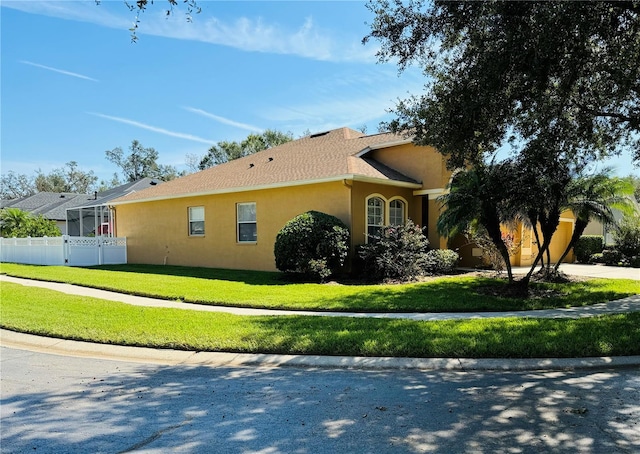 view of side of home with a lawn