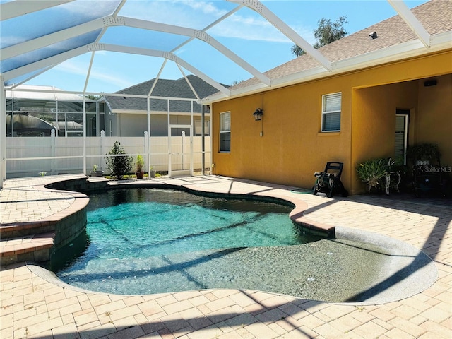 view of pool with a patio and a lanai