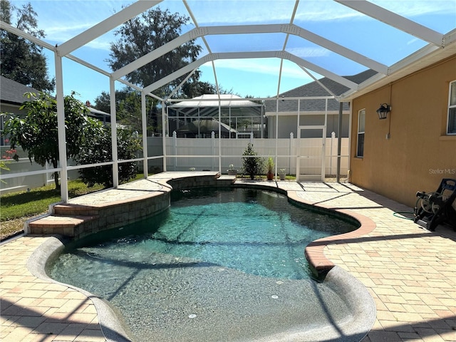 view of pool featuring a patio and glass enclosure