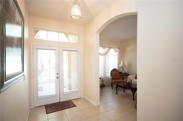 entrance foyer featuring french doors and light tile patterned flooring