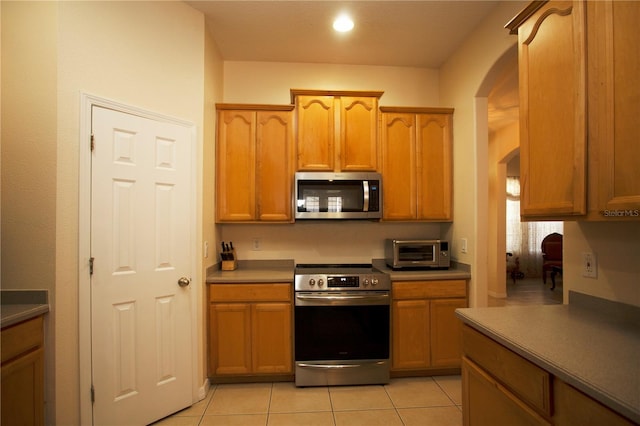 kitchen featuring stainless steel appliances and light tile patterned floors