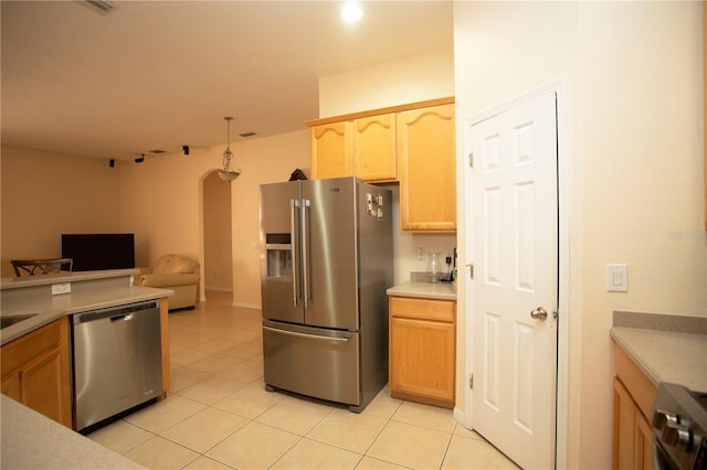 kitchen featuring pendant lighting, light brown cabinets, stainless steel appliances, and light tile patterned flooring