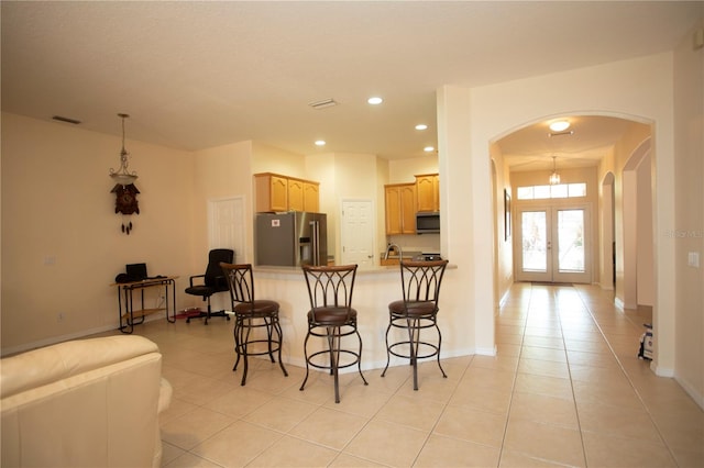 kitchen featuring french doors, light brown cabinets, stainless steel appliances, sink, and light tile patterned flooring