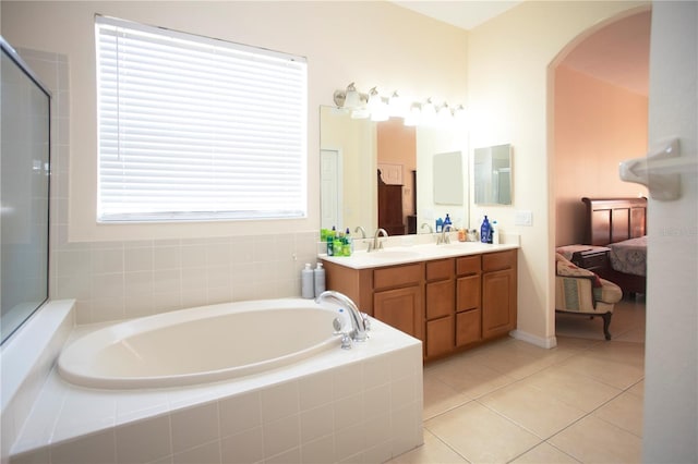 bathroom with vanity, independent shower and bath, and tile patterned flooring