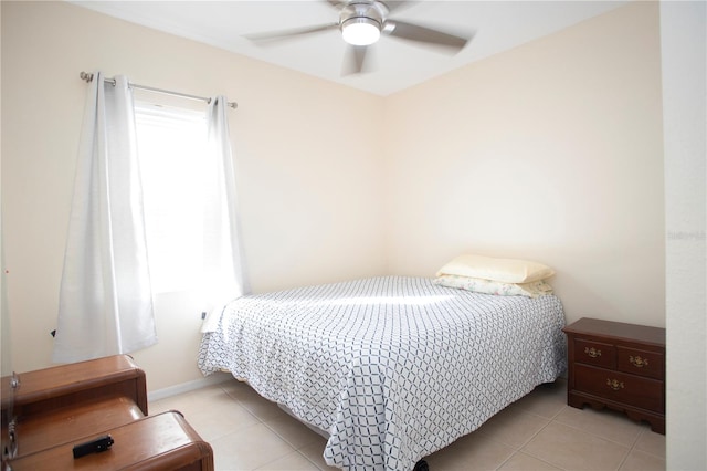 tiled bedroom featuring ceiling fan