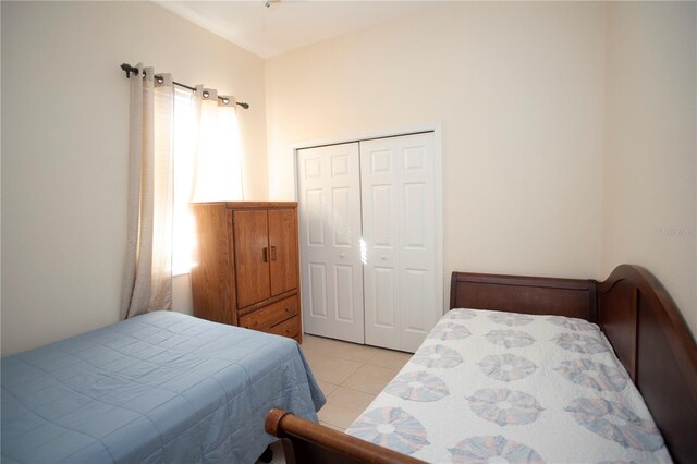 bedroom featuring a closet and light tile patterned floors