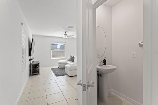 bathroom featuring ceiling fan, tile patterned flooring, and sink