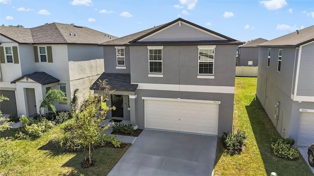 view of front facade featuring a front yard and a garage