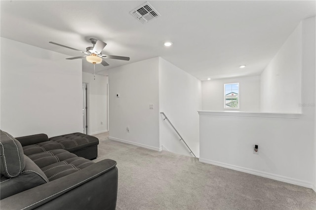 carpeted living room featuring ceiling fan