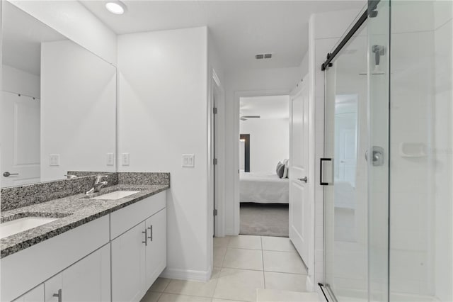 bathroom with tile patterned floors, an enclosed shower, and vanity