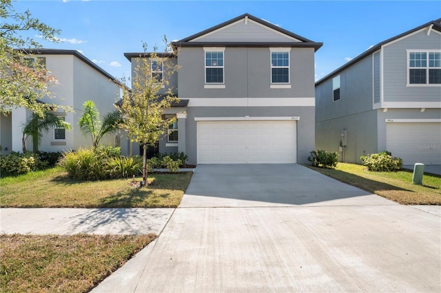 view of front property with a garage and a front yard