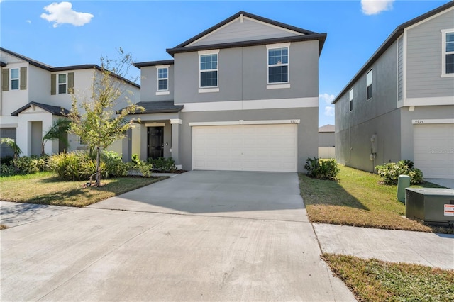 view of property with a garage and a front yard