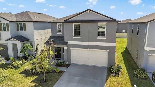 view of front of property with a garage and a front lawn