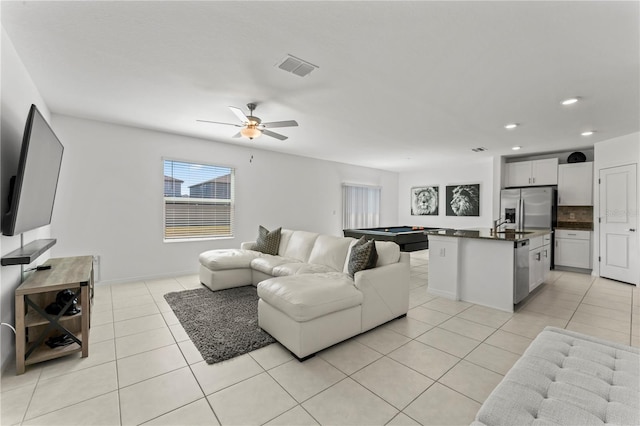 tiled living room featuring sink, ceiling fan, and billiards