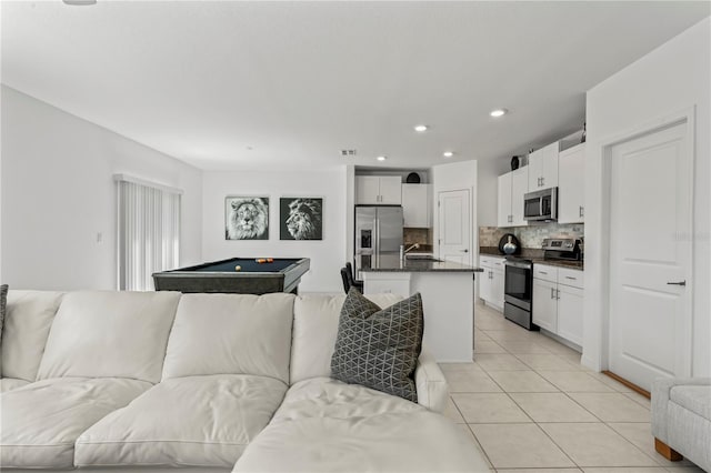 tiled living room featuring sink and billiards