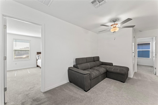 carpeted living room featuring ceiling fan