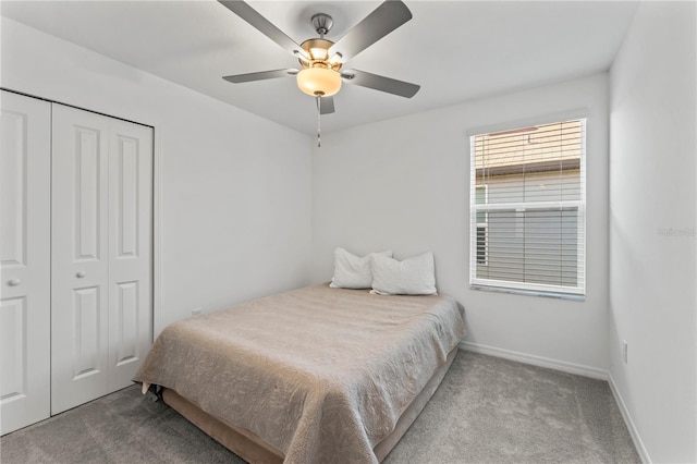 carpeted bedroom featuring a closet and ceiling fan