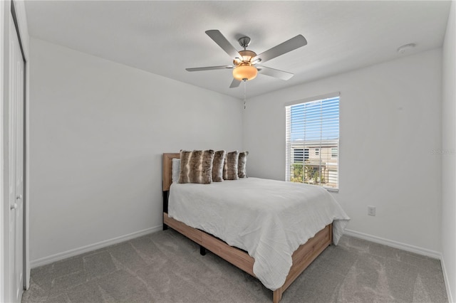 bedroom featuring ceiling fan, light carpet, and a closet