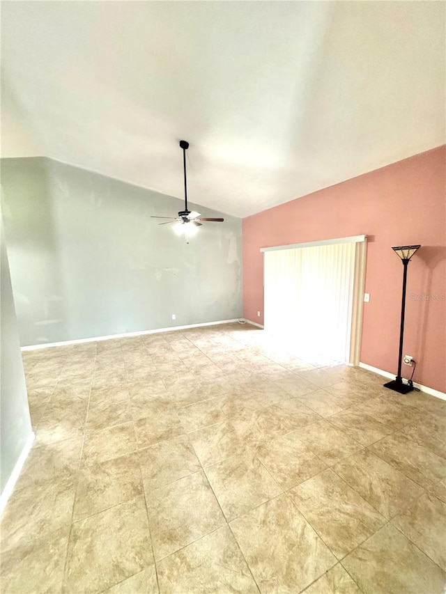 empty room with ceiling fan and lofted ceiling