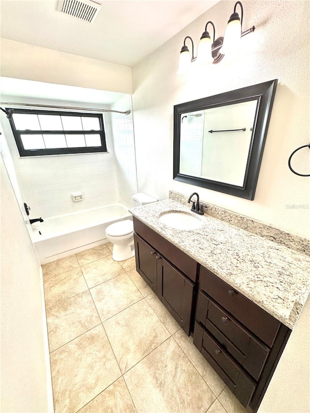 full bathroom featuring toilet, tiled shower / bath combo, vanity, and tile patterned floors