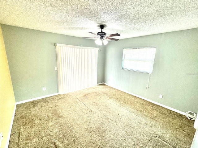 carpeted spare room with a textured ceiling and ceiling fan