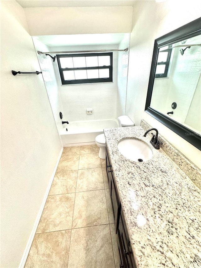 full bathroom featuring tiled shower / bath combo, vanity, tile patterned floors, and toilet