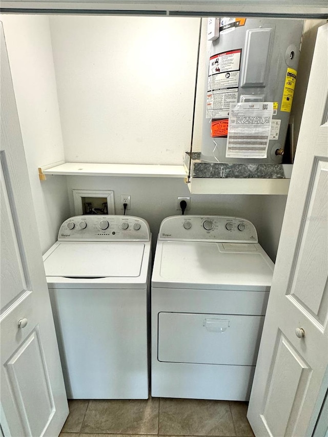 washroom with separate washer and dryer and tile patterned flooring