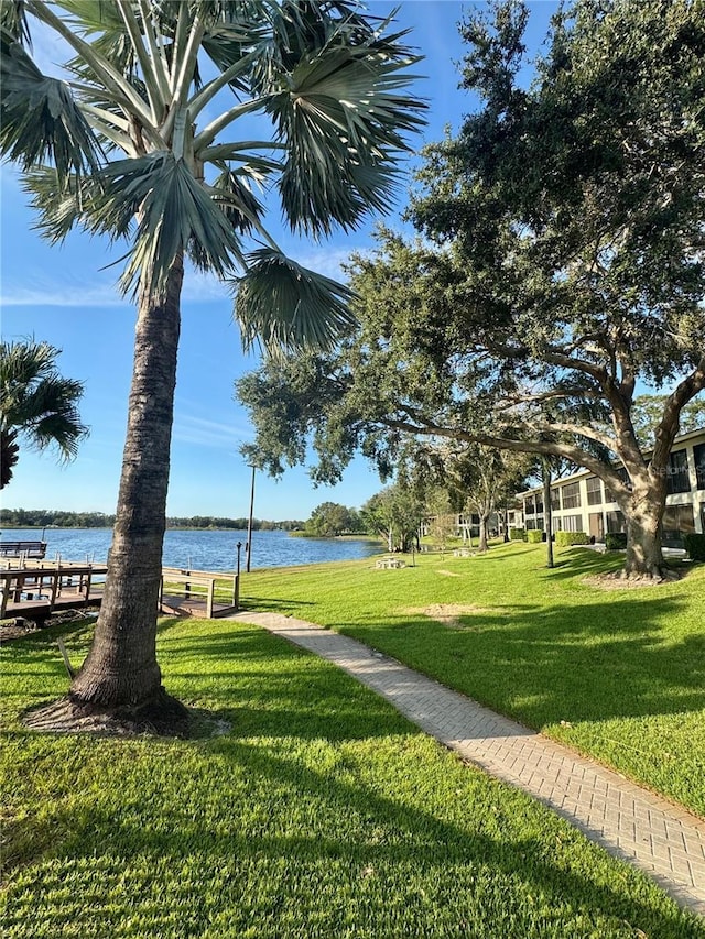 view of community featuring a water view and a lawn