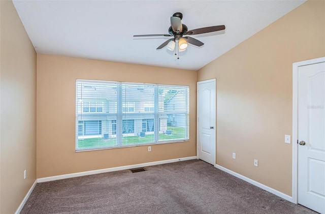 carpeted empty room featuring ceiling fan and lofted ceiling