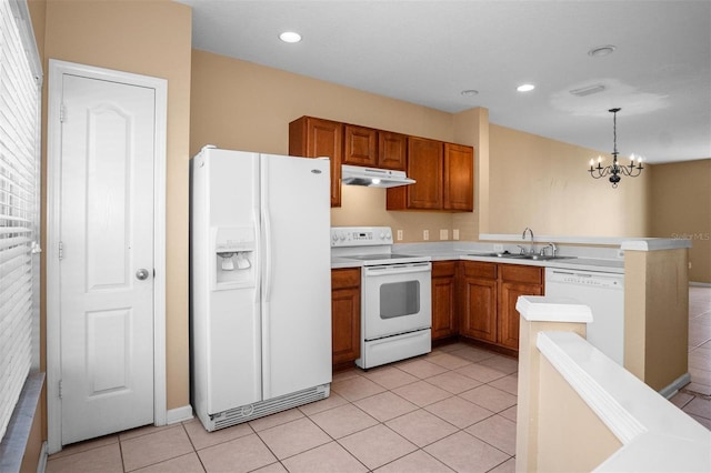 kitchen with sink, an inviting chandelier, decorative light fixtures, white appliances, and light tile patterned floors