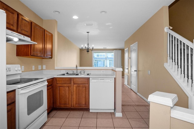 kitchen featuring white appliances, sink, light tile patterned floors, decorative light fixtures, and a chandelier