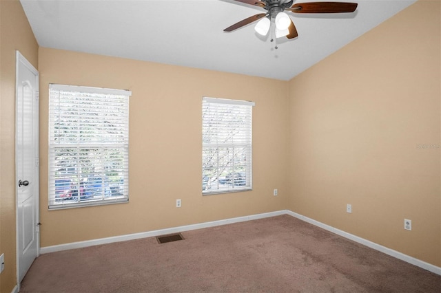 spare room featuring ceiling fan and carpet