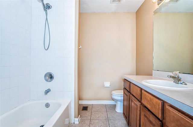 full bathroom with tiled shower / bath combo, tile patterned flooring, a textured ceiling, toilet, and vanity