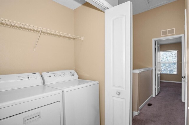 laundry area featuring washing machine and clothes dryer and carpet floors