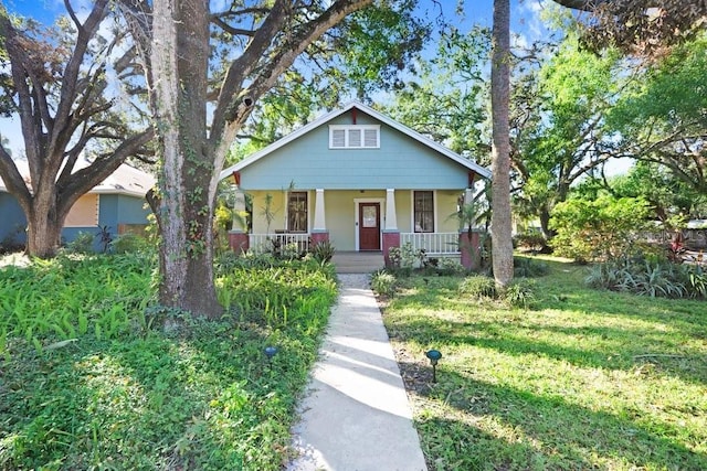 view of front of house with a porch and a front lawn