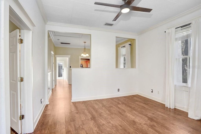 empty room with hardwood / wood-style floors, crown molding, and ceiling fan