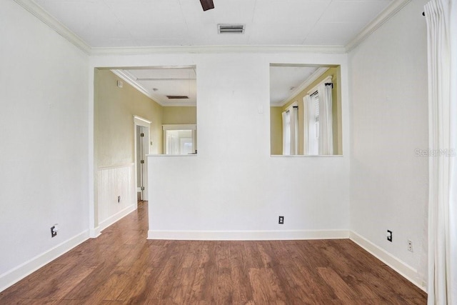 spare room featuring ornamental molding and dark hardwood / wood-style flooring