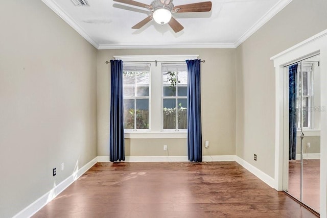 unfurnished room with crown molding, wood-type flooring, and ceiling fan