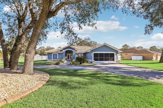 single story home with a front yard and a garage