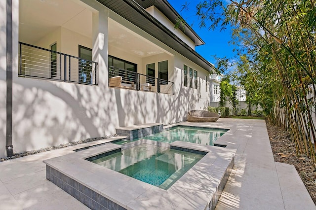 view of swimming pool featuring an in ground hot tub and a patio area